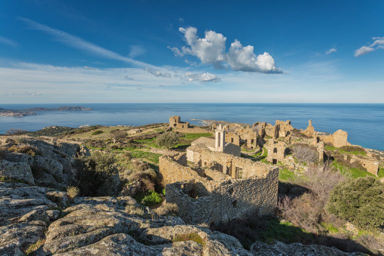 Ruined buildings and the restored church in the abandoned village of Occi near Lumio in the Balagne region of Corsica
